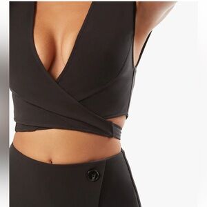 We Wore What | sz large NWoT | Tie Back Suiting Wrap Top in black. Sold out.